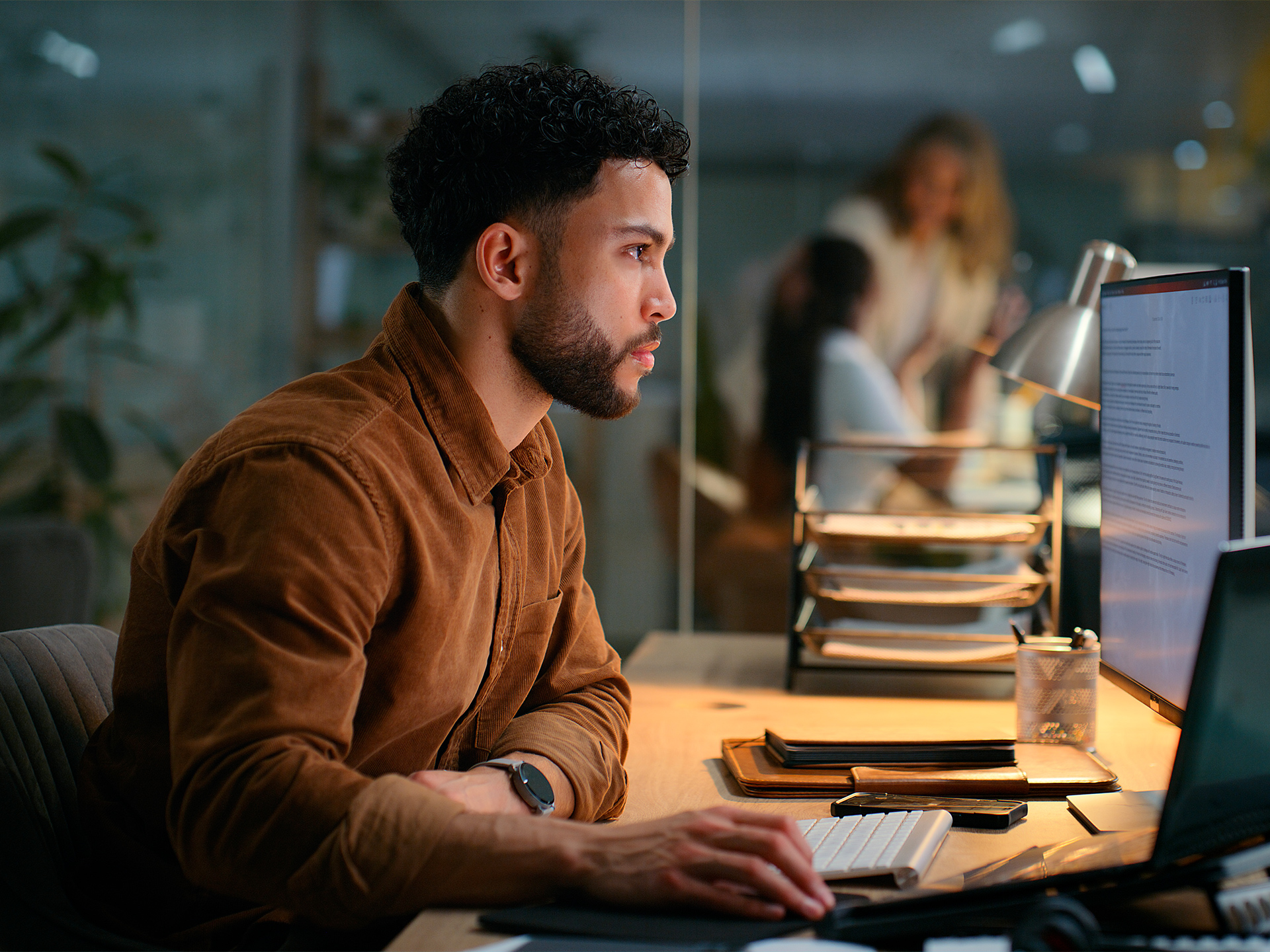 professional focused on computer work in quiet office environment