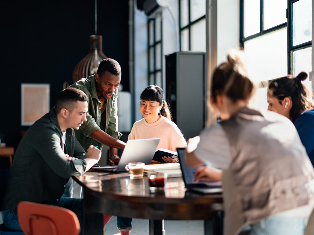business team collaborating around table during workshop meeting